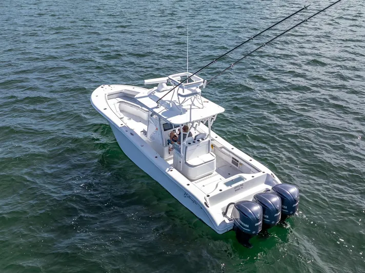 Yacht Photos Pics 2021 Yellowfin 34 boat with triple Yamaha engines on open water.