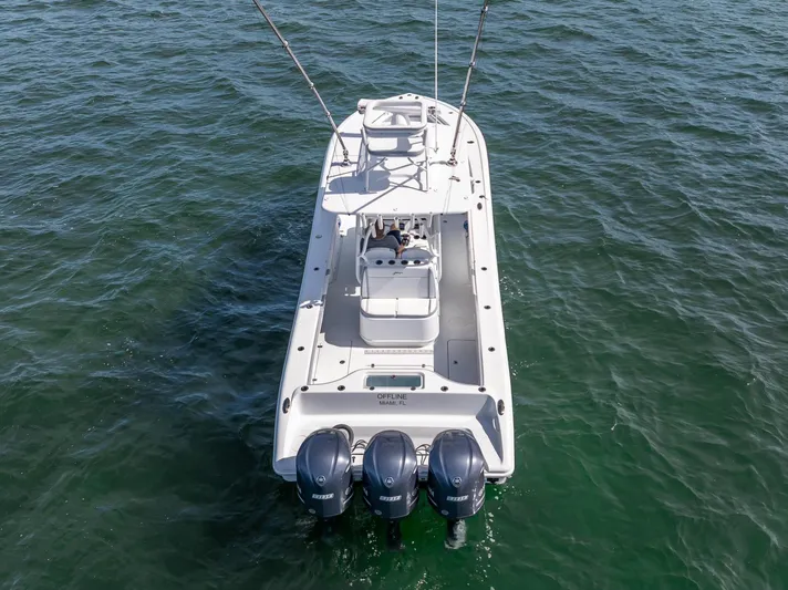  Yacht Photos Pics 2021 Yellowfin 34 boat with triple outboard engines on open water.