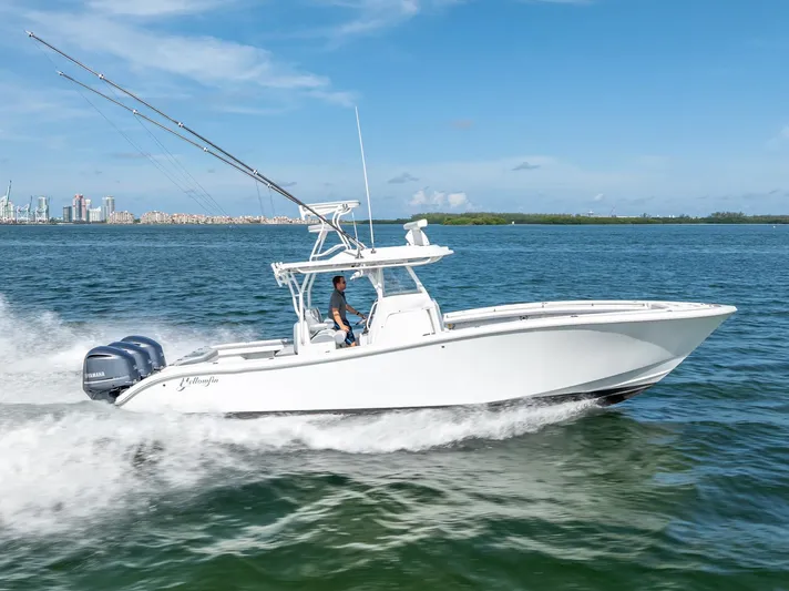  Yacht Photos Pics 2021 Yellowfin 34 boat cruising on open water under clear blue sky.