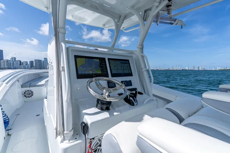  Yacht Photos Pics 2021 Yellowfin 34 boat dashboard with city skyline and ocean view.