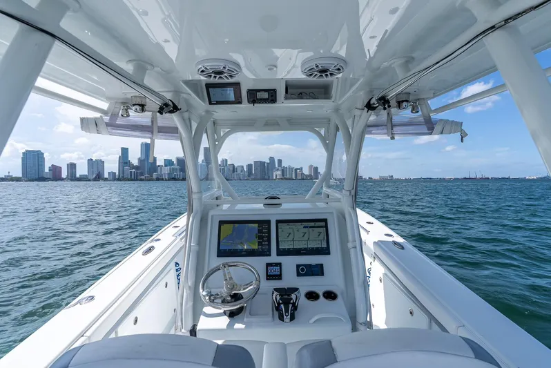  Yacht Photos Pics 2021 Yellowfin 34 boat dashboard with city skyline view on the water.