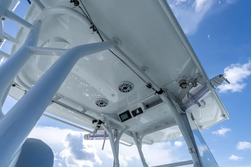  Yacht Photos Pics 2021 Yellowfin 34 boat canopy with speakers and equipment against blue sky.
