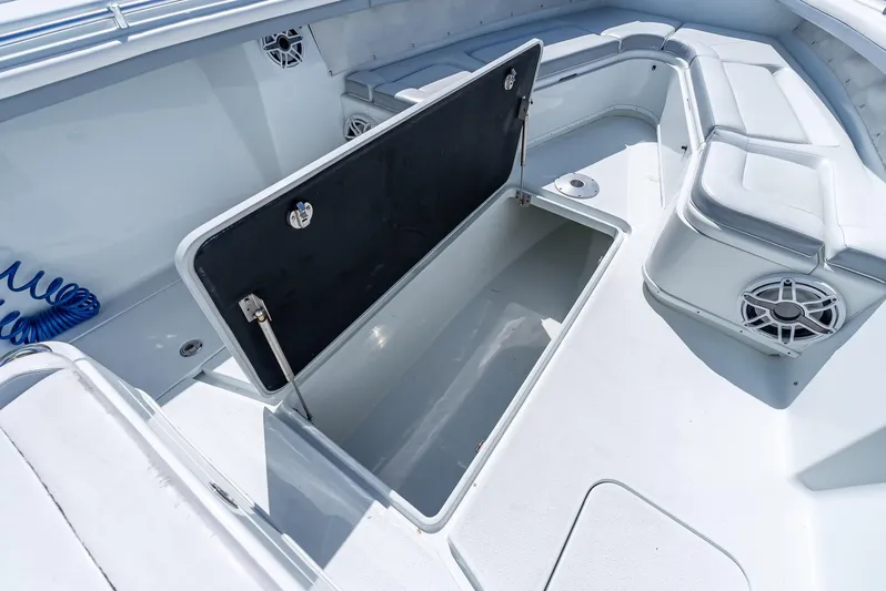  Yacht Photos Pics 2021 Yellowfin 34 boat interior with open storage compartment and seating area.