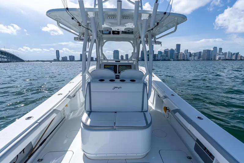  Yacht Photos Pics 2021 Yellowfin 34 boat cruising with city skyline and bridge in background.