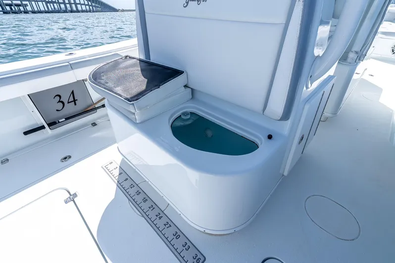  Yacht Photos Pics 2021 Yellowfin 34 boat interior with livewell and measuring ruler on deck.