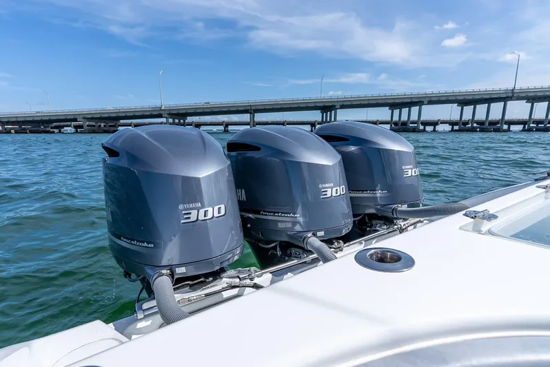  Yacht Photos Pics Triple Yamaha 300 engines on a 2021 Yellowfin 34 boat near a bridge.