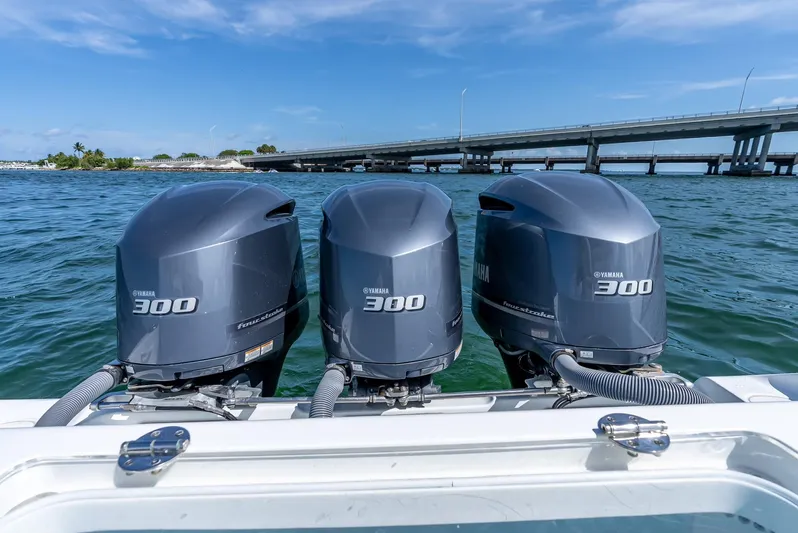  Yacht Photos Pics Triple Yamaha 300 outboard engines on a 2021 Yellowfin 34 boat, near a bridge.