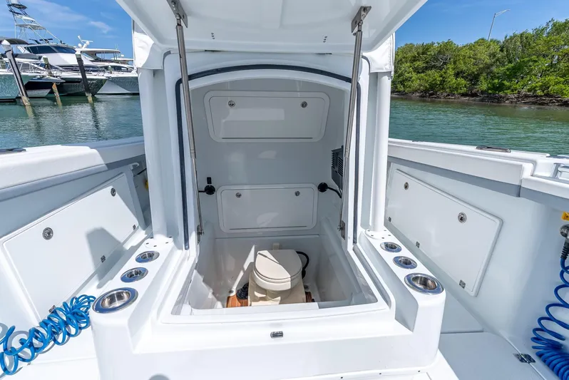  Yacht Photos Pics 2021 Yellowfin 34 boat interior with open hatch and storage compartments.