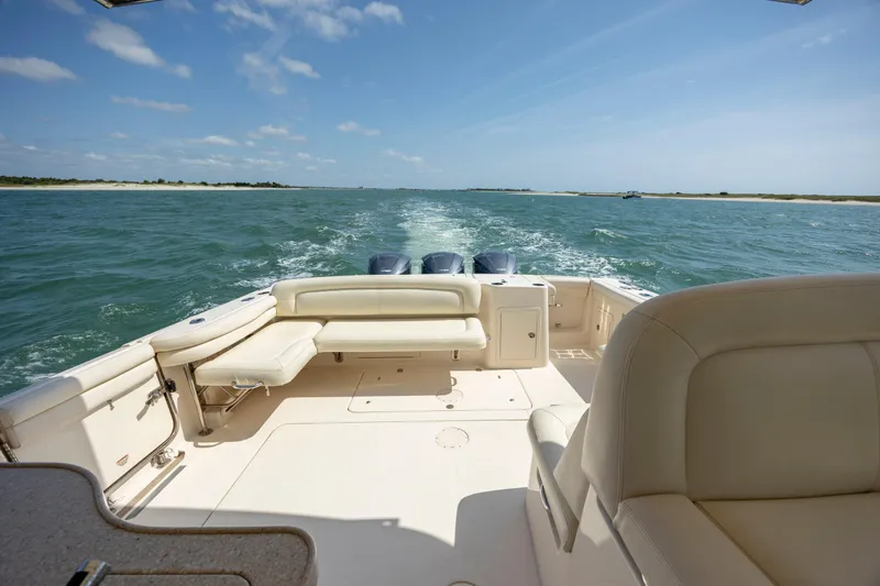  Yacht Photos Pics 2015 Grady-White Freedom 375 boat cruising on open water, clear sky, spacious seating.