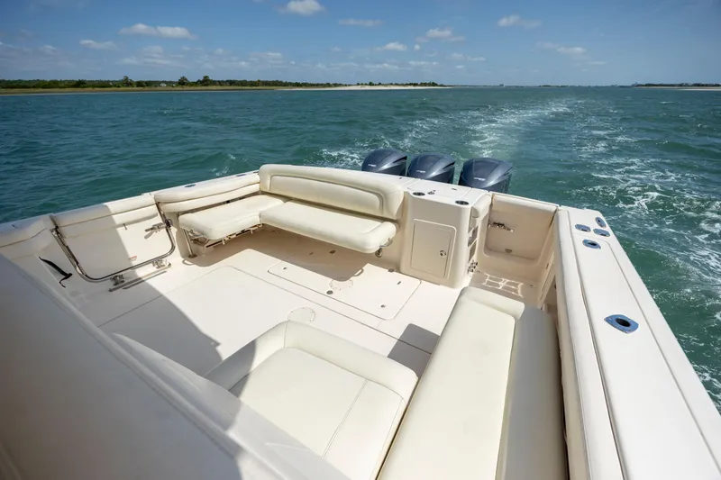  Yacht Photos Pics 2015 Grady-White Freedom 375 boat cruising on open water, featuring spacious seating.