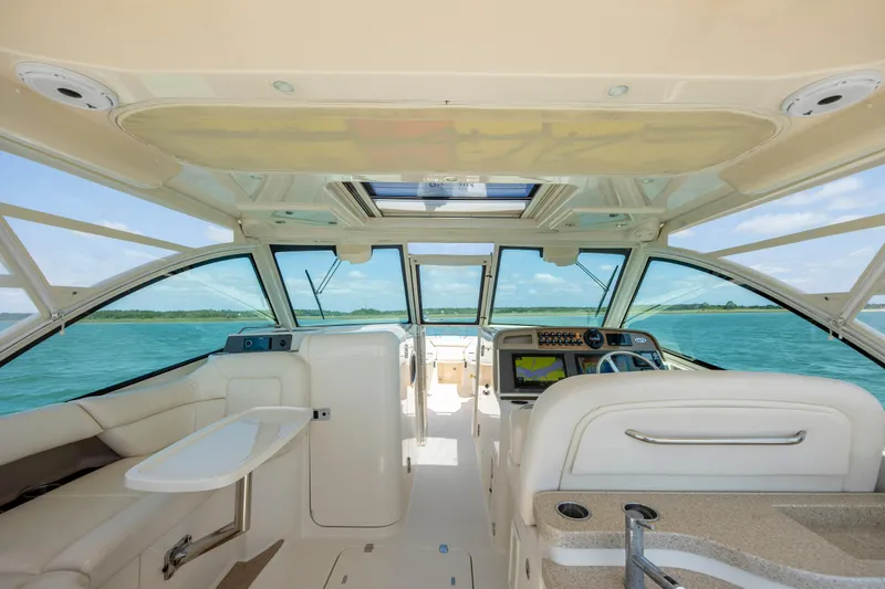  Yacht Photos Pics Interior view of 2015 Grady-White Freedom 375 boat with luxurious seating and ocean backdrop.