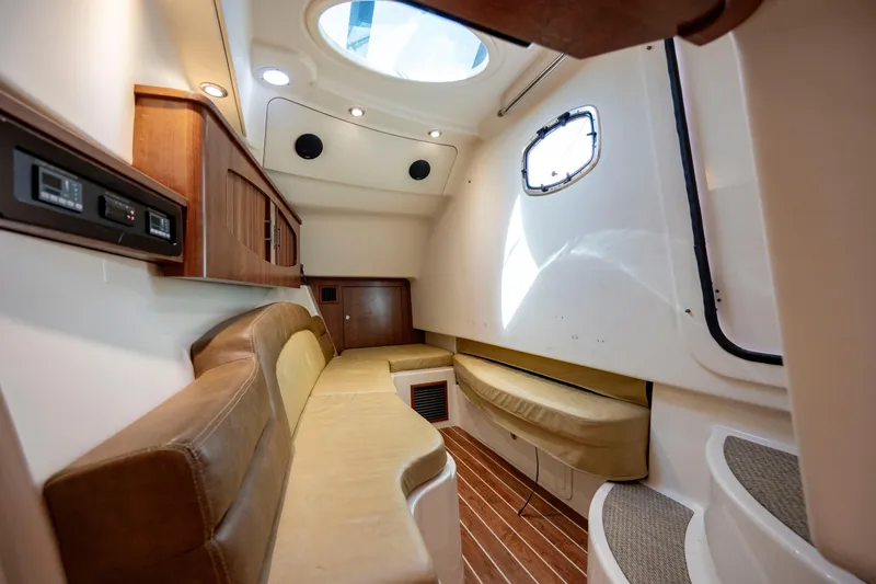  Yacht Photos Pics Interior of 2015 Grady-White Freedom 375 boat, featuring cozy seating and elegant wood finishes.