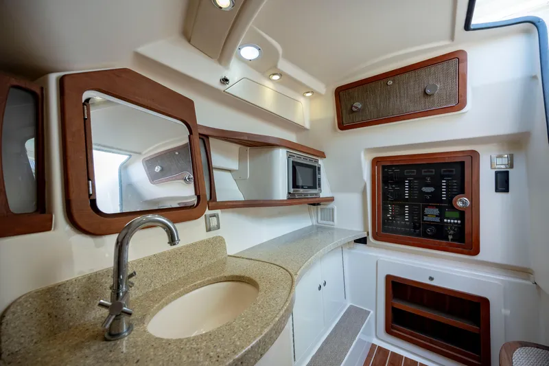  Yacht Photos Pics 2015 Grady-White Freedom 375 boat interior with sink, microwave, and control panel.