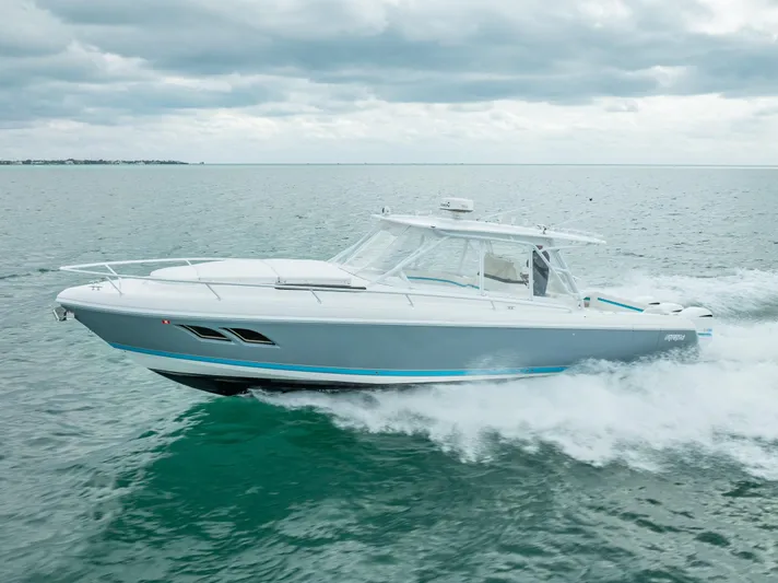  Yacht Photos Pics 2015 Intrepid 400 Cuddy cruising on open water under cloudy skies.