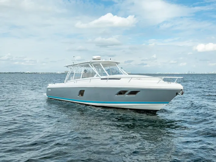  Yacht Photos Pics 2015 Intrepid 400 Cuddy boat on open water under a cloudy sky.