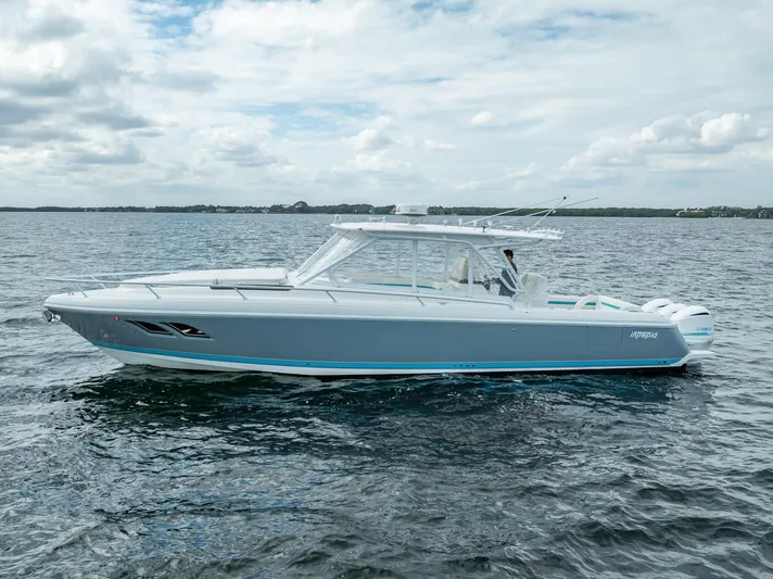  Yacht Photos Pics 2015 Intrepid 400 Cuddy boat on open water under cloudy sky.