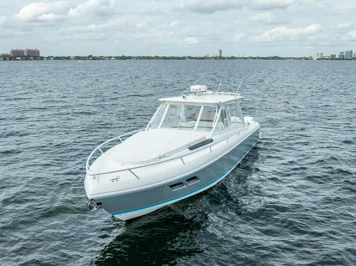  Yacht Photos Pics 2015 Intrepid 400 Cuddy boat cruising on open water under cloudy skies.
