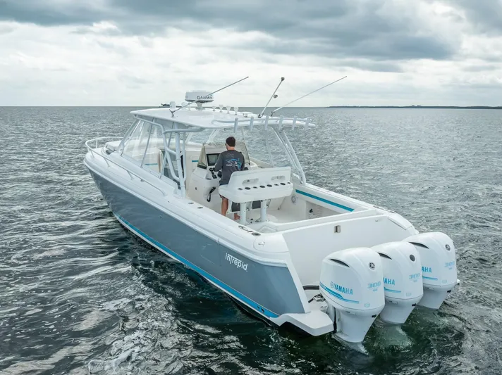  Yacht Photos Pics 2015 Intrepid 400 Cuddy boat cruising on open water under cloudy skies.