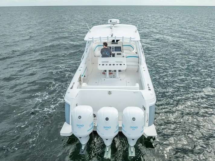  Yacht Photos Pics 2015 Intrepid 400 Cuddy boat on open water, rear view with triple engines.