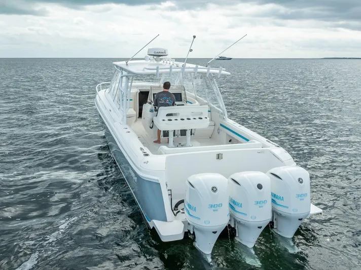  Yacht Photos Pics 2015 Intrepid 400 Cuddy boat with triple Yamaha engines on open water.