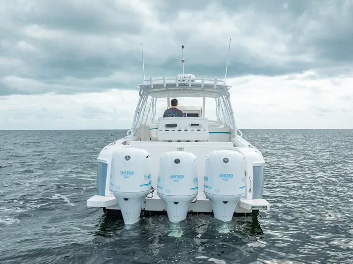  Yacht Photos Pics 2015 Intrepid 400 Cuddy boat with triple outboard engines on open water.