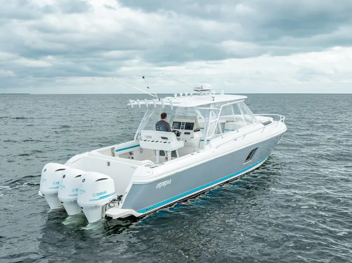  Yacht Photos Pics 2015 Intrepid 400 Cuddy boat cruising on open water under cloudy skies.