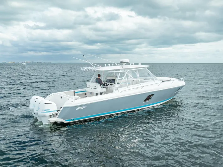  Yacht Photos Pics 2015 Intrepid 400 Cuddy boat cruising on open water under cloudy skies.