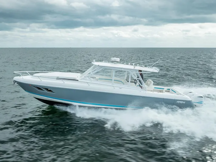  Yacht Photos Pics 2015 Intrepid 400 Cuddy cruising on open water under cloudy skies.