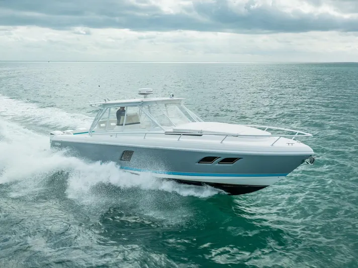  Yacht Photos Pics 2015 Intrepid 400 Cuddy cruising on open water under cloudy skies.