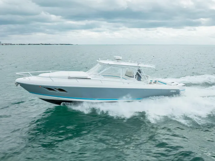  Yacht Photos Pics 2015 Intrepid 400 Cuddy cruising on open water under cloudy skies.