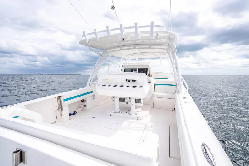  Yacht Photos Pics 2015 Intrepid 400 Cuddy boat on open water, featuring spacious deck and seating.