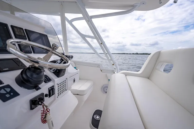  Yacht Photos Pics 2015 Intrepid 400 Cuddy helm with white seating, steering wheel, and ocean view.