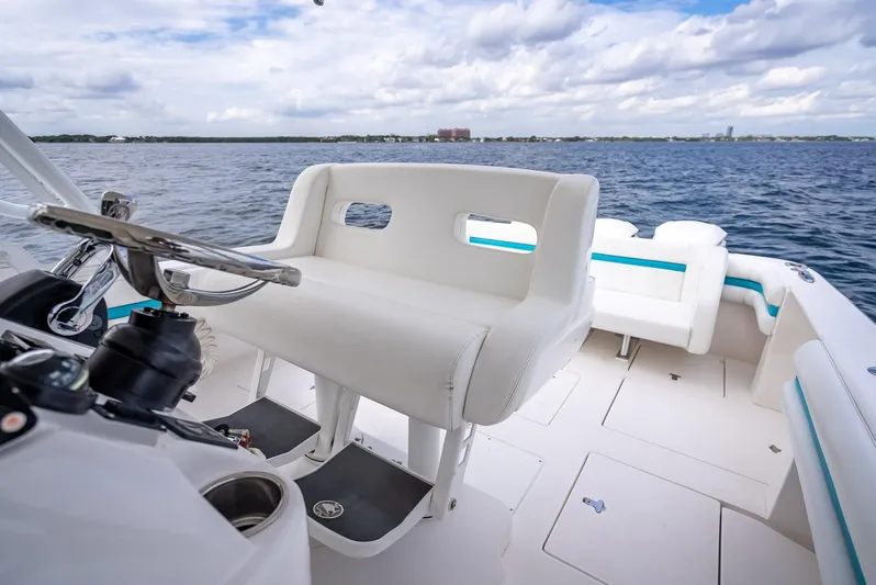  Yacht Photos Pics 2015 Intrepid 400 Cuddy boat interior with white seating, steering wheel, and ocean view.