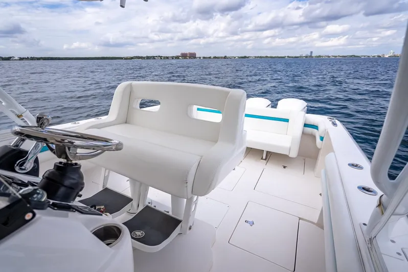 Yacht Photos Pics 2015 Intrepid 400 Cuddy boat interior with white seating, steering wheel, and ocean view.