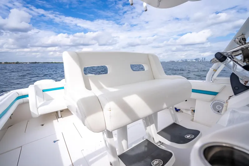  Yacht Photos Pics 2015 Intrepid 400 Cuddy boat interior with white seating, ocean view, and blue sky.