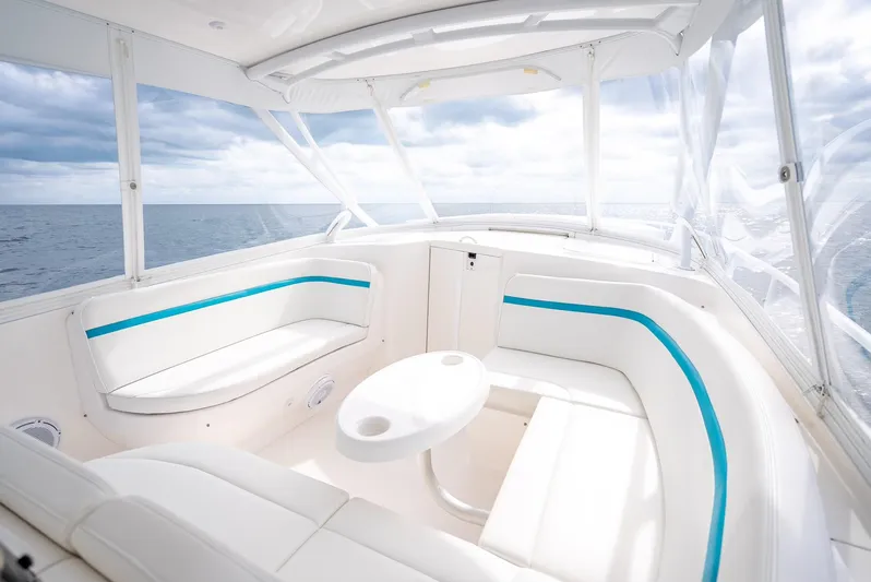  Yacht Photos Pics 2015 Intrepid 400 Cuddy interior with white seating and ocean view.