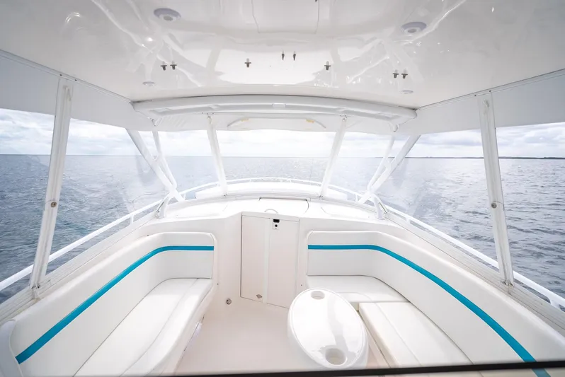  Yacht Photos Pics 2015 Intrepid 400 Cuddy interior with ocean view, featuring white seating and blue accents.