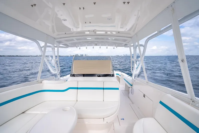  Yacht Photos Pics 2015 Intrepid 400 Cuddy boat interior with white seating, ocean view, and blue accents.