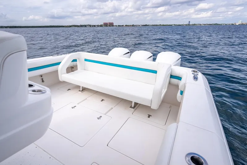  Yacht Photos Pics 2015 Intrepid 400 Cuddy boat with spacious deck and seating on open water.