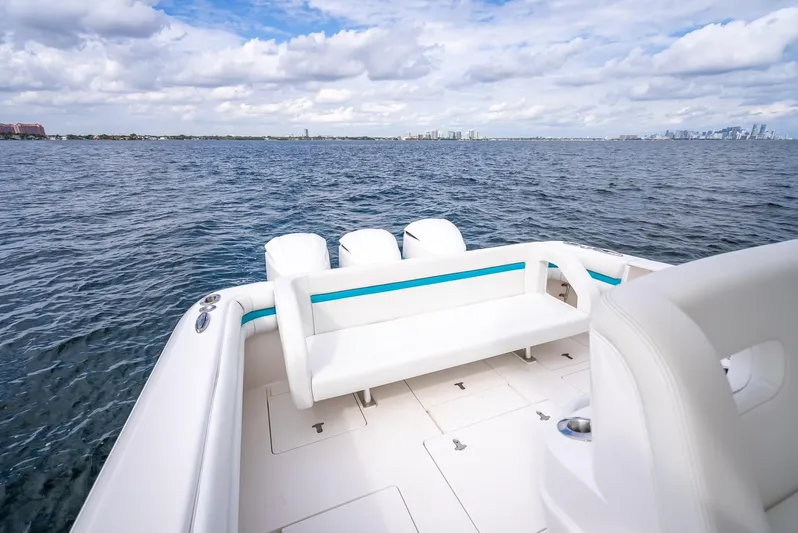  Yacht Photos Pics 2015 Intrepid 400 Cuddy boat on open water, featuring spacious seating and triple engines.