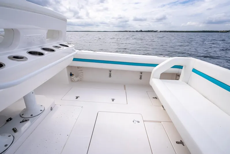  Yacht Photos Pics 2015 Intrepid 400 Cuddy boat interior with seating and rod holders on a calm sea.