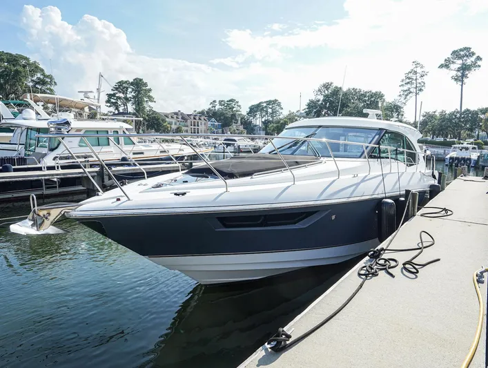  Yacht Photos Pics 2016 Cruisers Yachts 45 Cantius docked at marina, sunny day, surrounded by other boats.