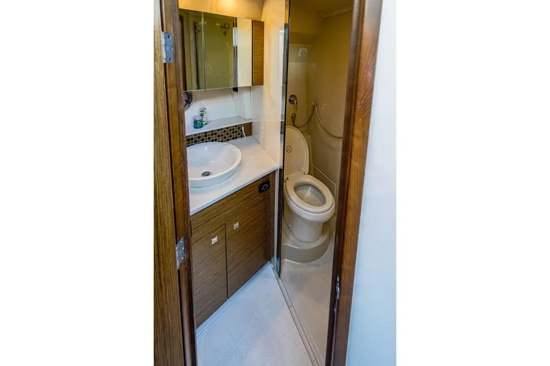  Yacht Photos Pics Bathroom interior of 2016 Cruisers Yachts 45 Cantius, featuring sink and toilet.