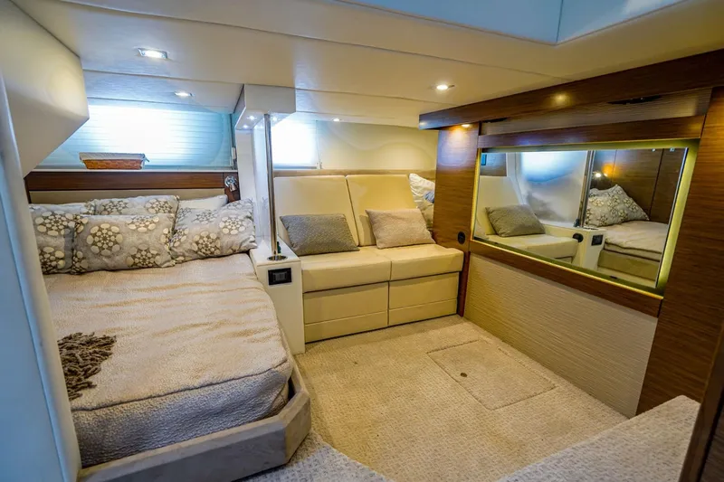  Yacht Photos Pics Luxurious interior of 2016 Cruisers Yachts 45 Cantius with cozy bed and seating area.