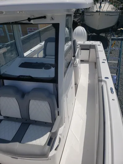  Yacht Photos Pics 2023 Everglades 285CC boat with sleek design and spacious seating.