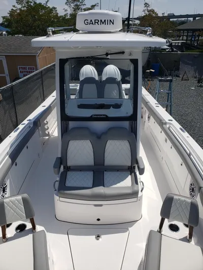  Yacht Photos Pics 2023 Everglades 285CC boat with Garmin equipment, featuring sleek seating and modern design.