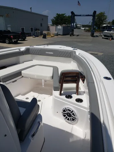  Yacht Photos Pics 2023 Everglades 285CC boat interior with seating and speaker, docked outdoors.