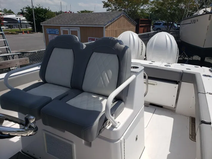  Yacht Photos Pics 2023 Everglades 285CC boat with dual cushioned seats and outboard motors.