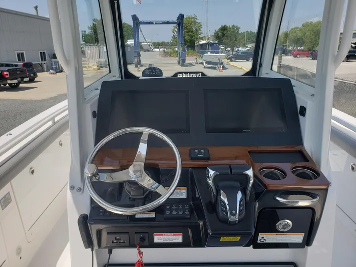  Yacht Photos Pics 2023 Everglades 285CC boat dashboard with steering wheel and dual screens.
