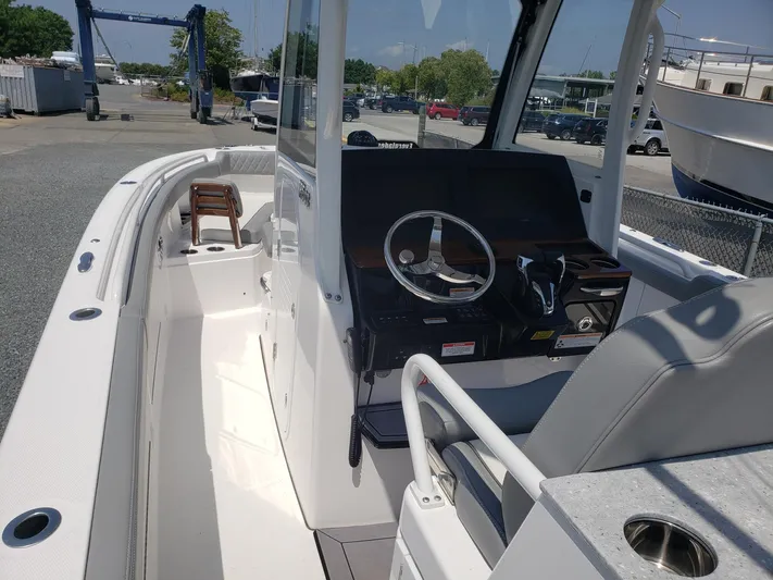  Yacht Photos Pics 2023 Everglades 285CC boat interior with steering console and seating.